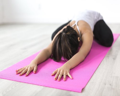 Person doing gentle stretching exercises on a yoga mat